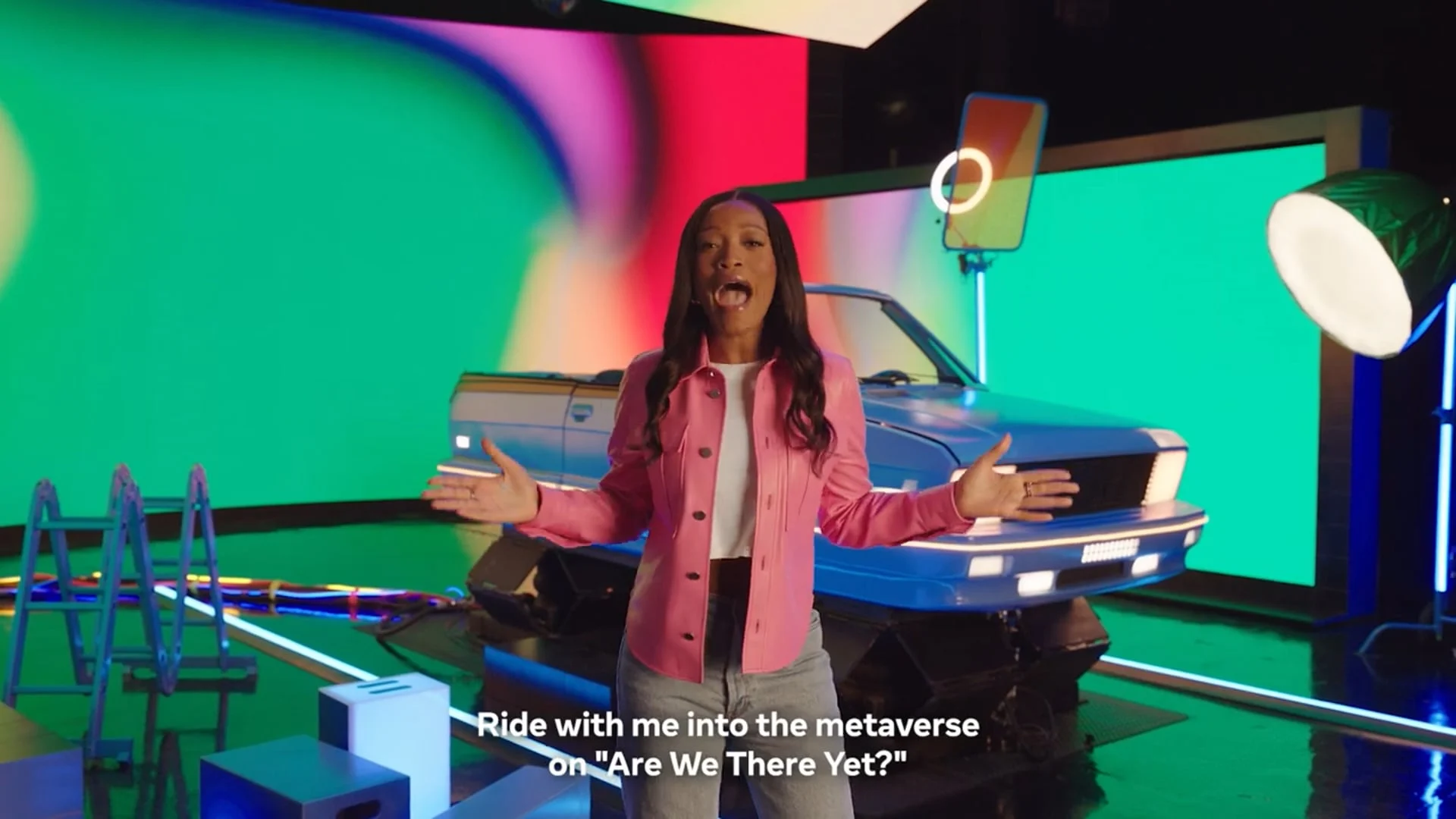 Host presenting in front of a neon car set