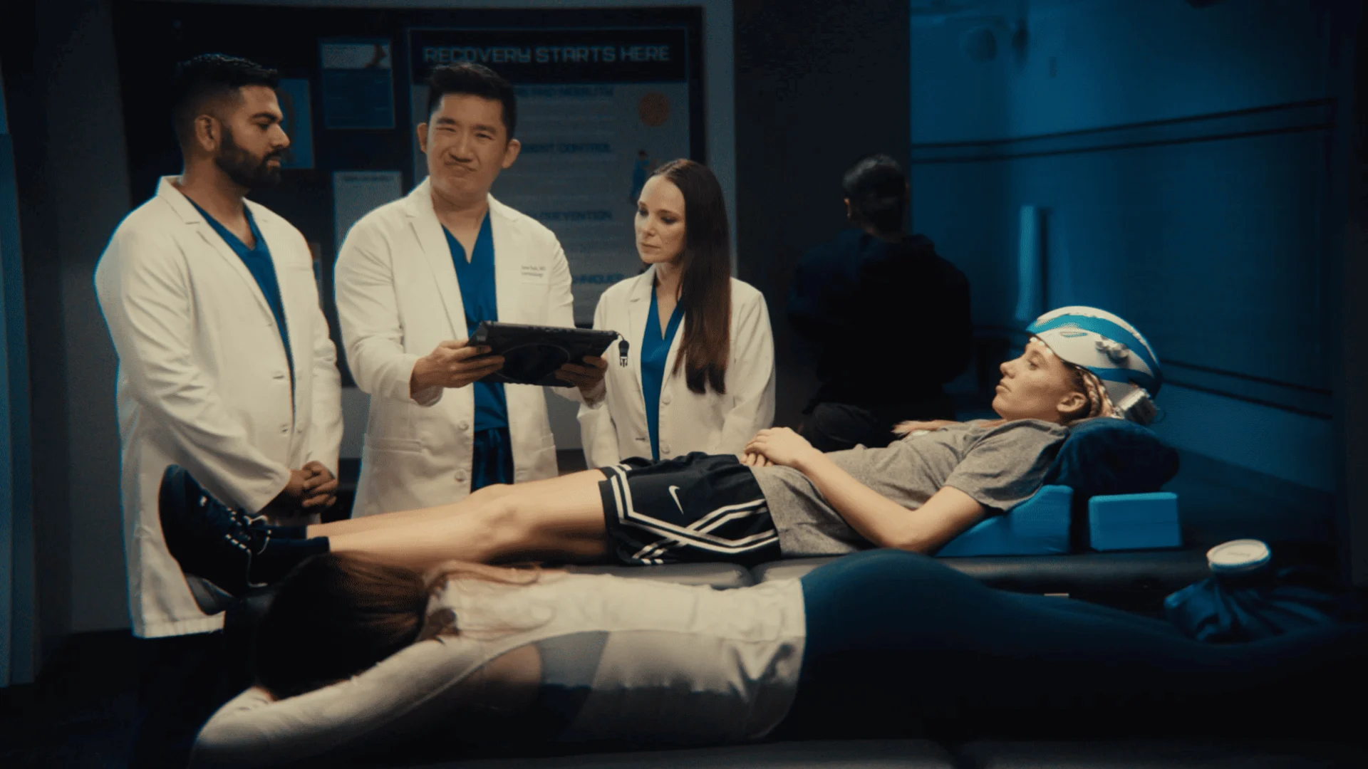 Doctors gathered around a patient on a recovery table